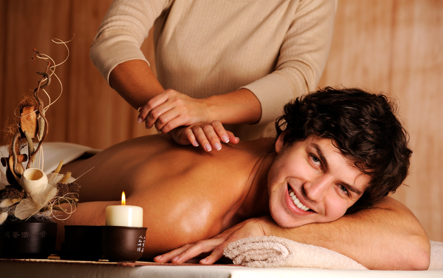 masseur doing massage handsome happy young man